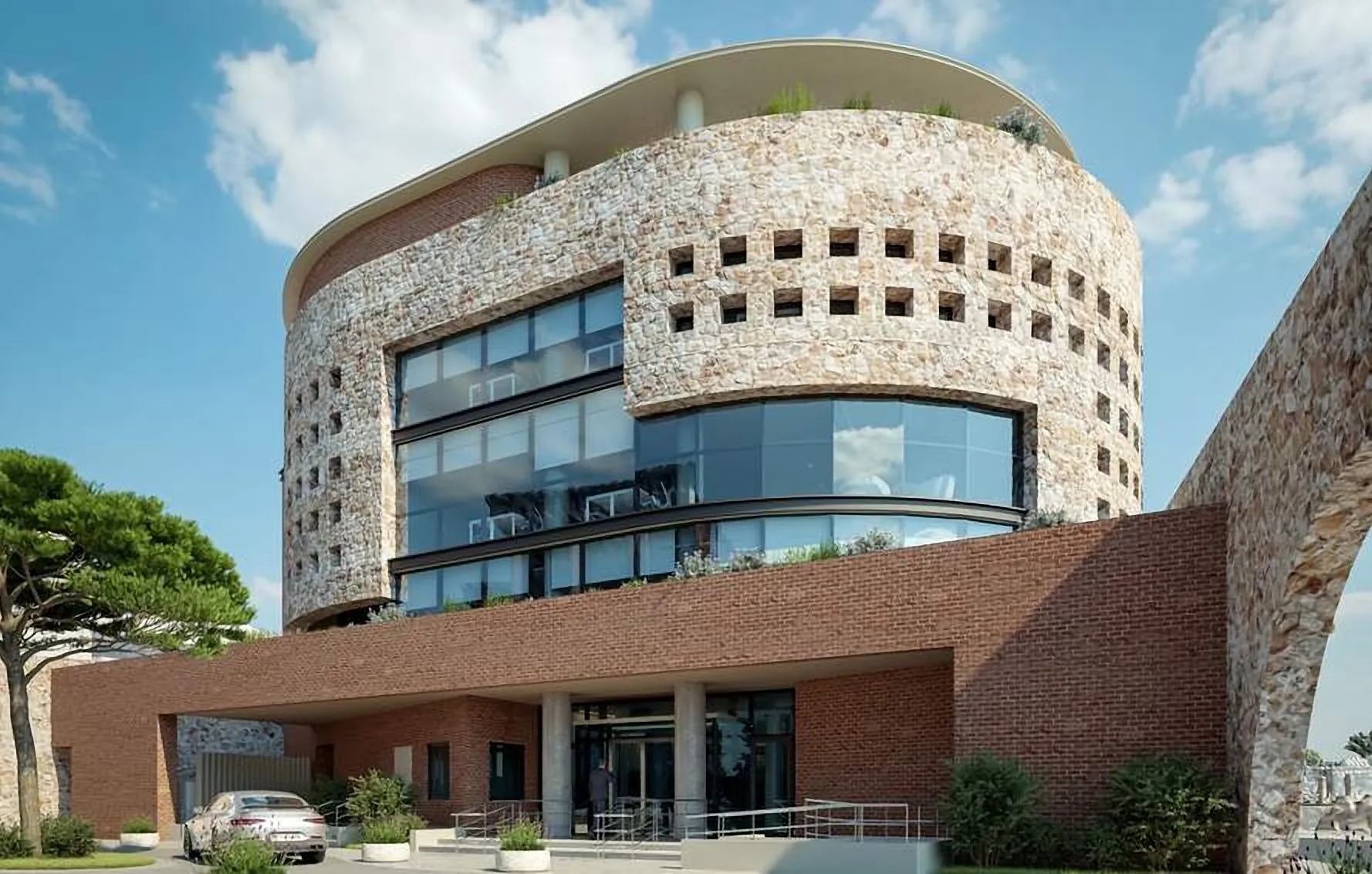 Round headquarters building with a perforated stone screen above a brick base