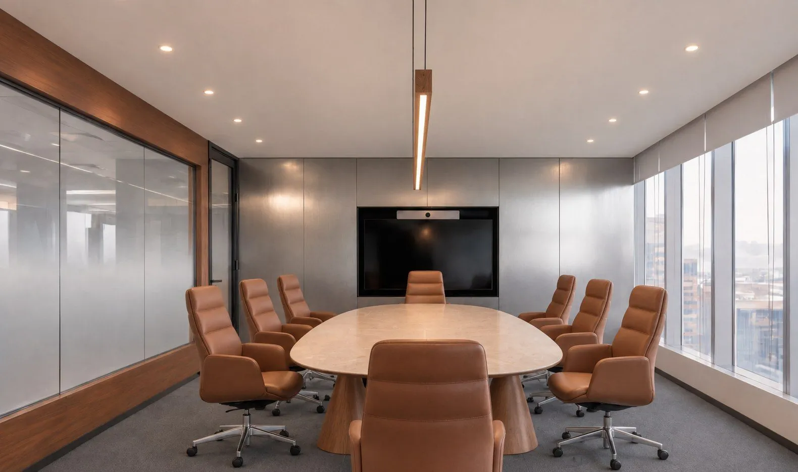 Meeting room with an oval table and tan leather chairs