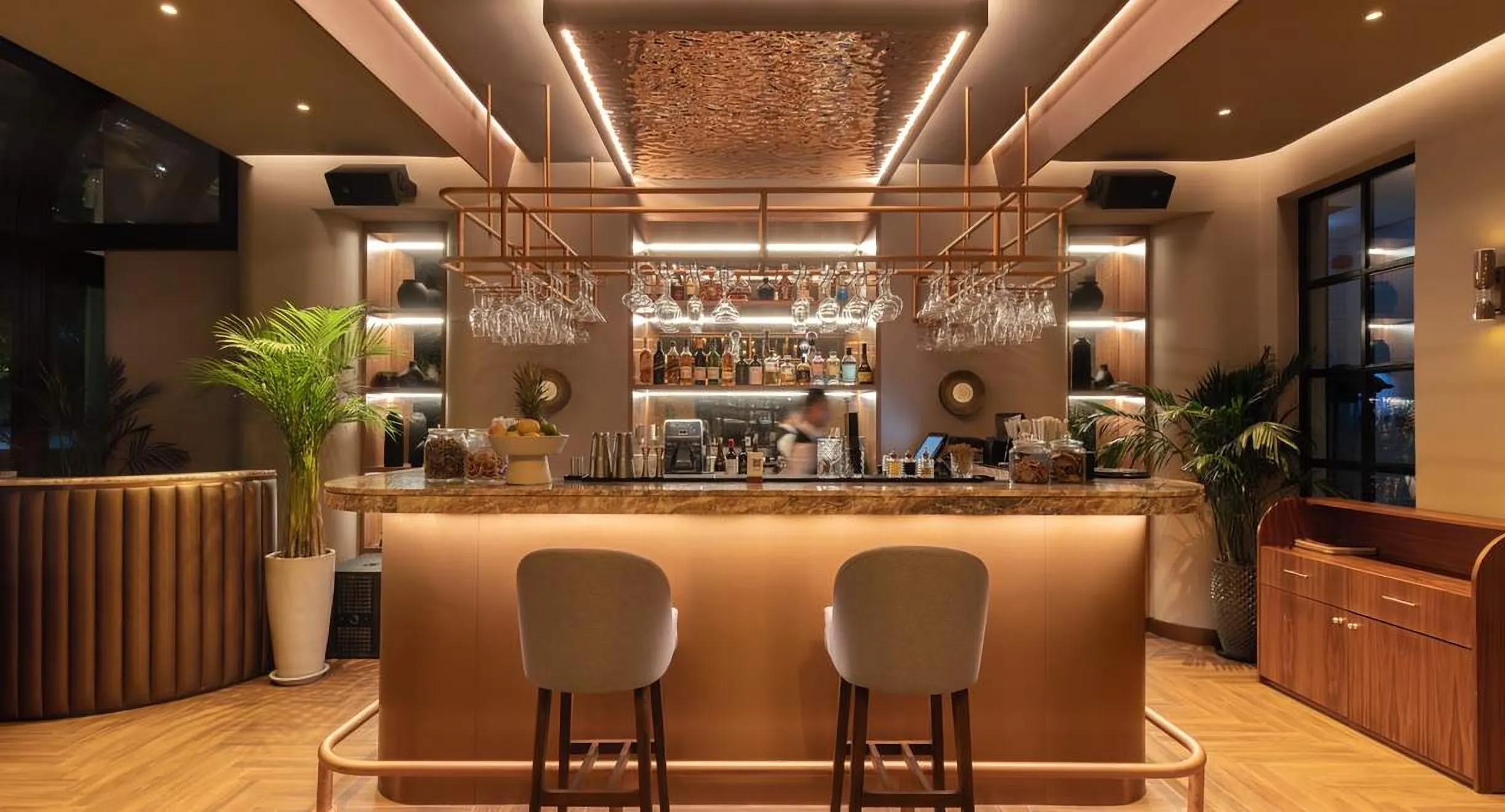 Copper-toned bar with tall stools