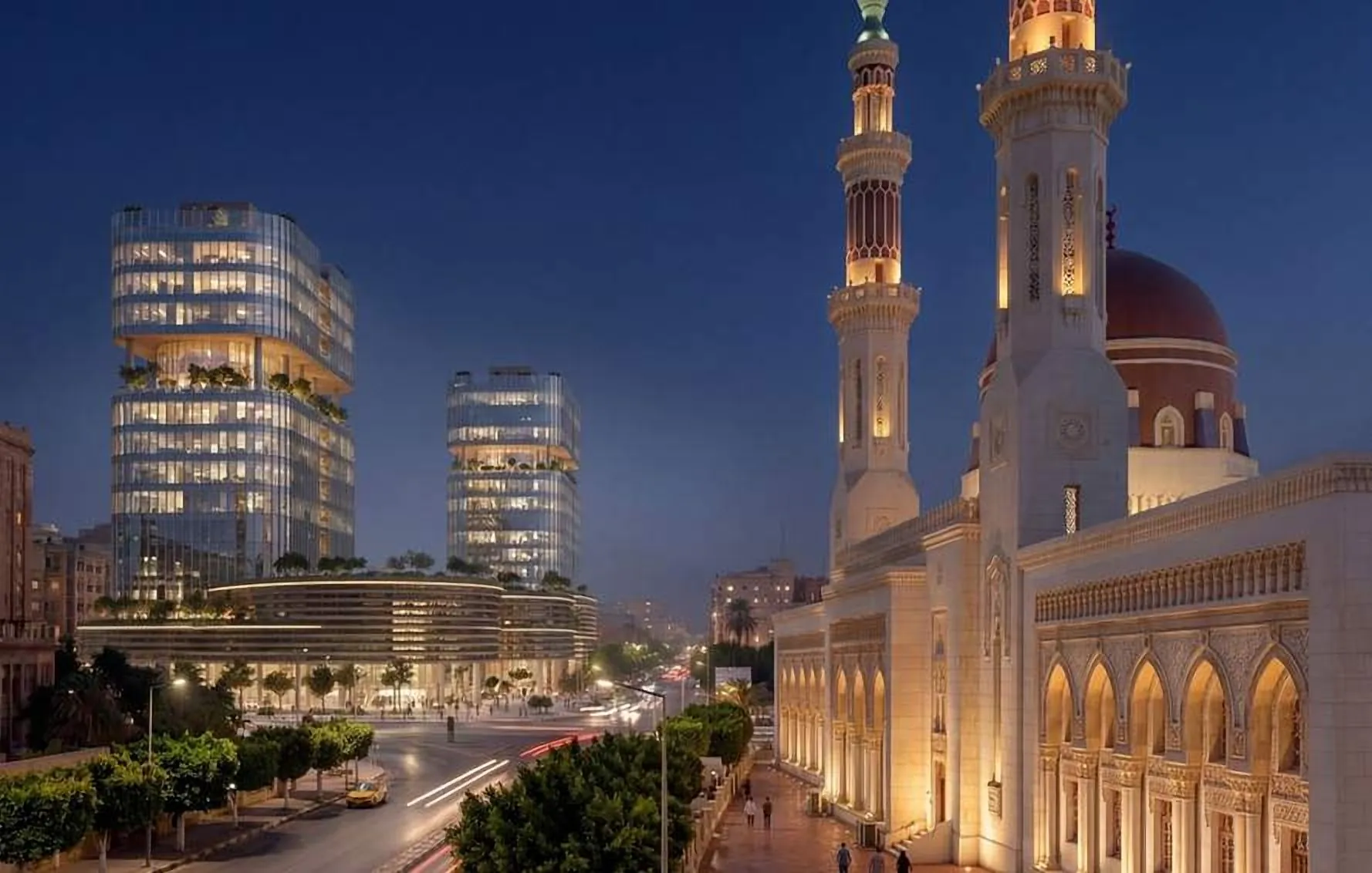Towers seen beside the lit minarets of the mosque