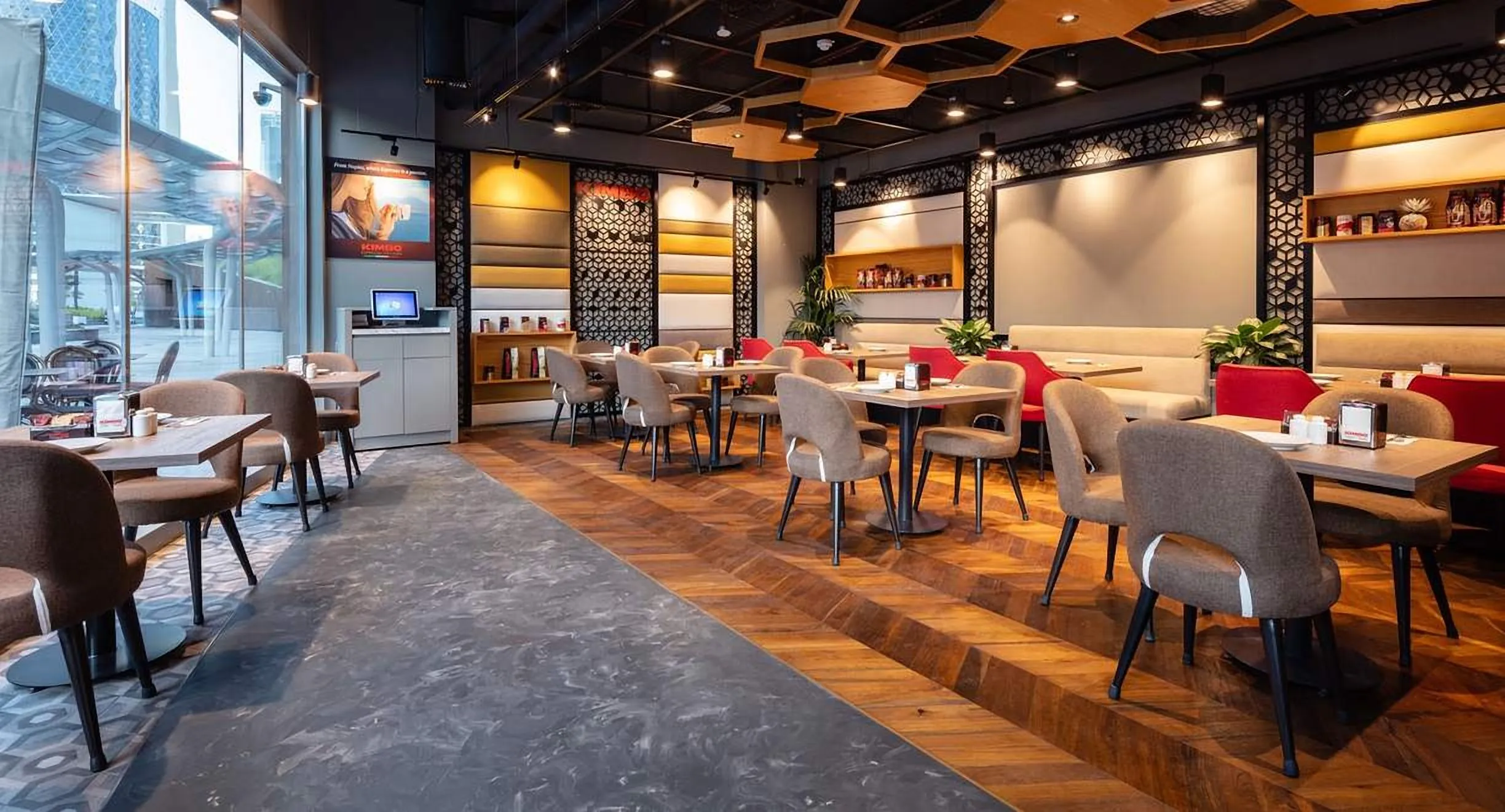 Espresso bar with dark timber, glowing counters and long tables