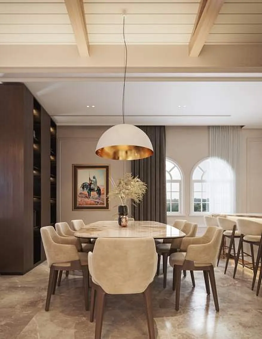 Dining room under a brass pendant with arched windows
