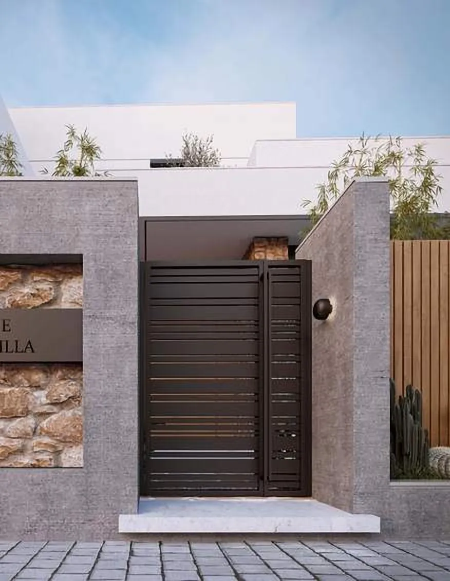 Gate in a concrete and stone boundary wall